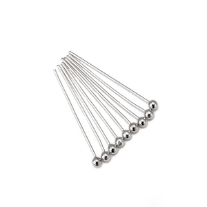 Detailed view of ten silver-colored metal ball head pins for DIY jewelry making