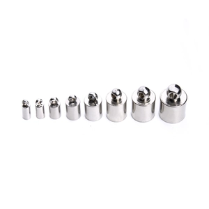 Detailed view of 8 sizes of polished stainless steel tassel caps and cord ends for DIY jewelry