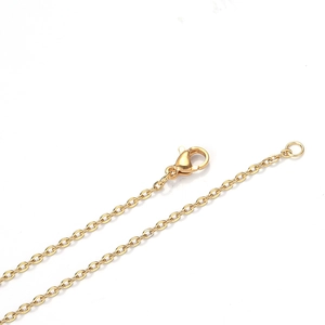 Detail of gold-plated stainless steel cross chain featuring a secure lobster clasp