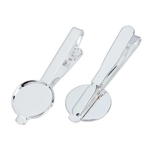 Detailed macro view of silver polished metal tie clip base and round tray for DIY jewelry