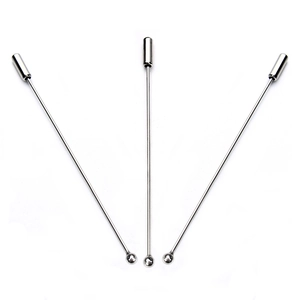 Three long silver metal brooch pins with round heads and safety caps on white background