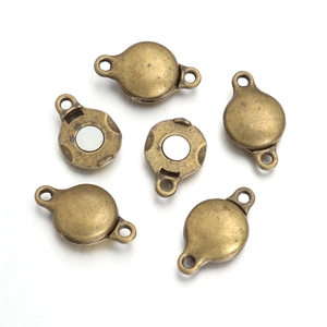 Detailed macro view of vintage bronze magnetic clasps for DIY jewelry making