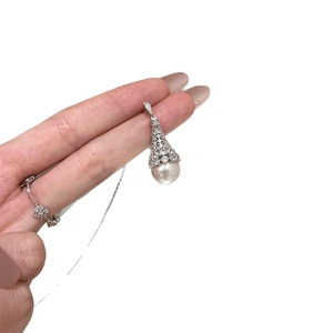 Elegant silver zircon encrusted bell pendant with round white pearl on thin chain