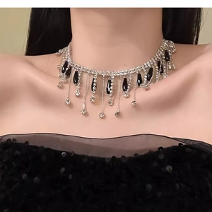 Close-up of vintage Y2K style choker with black glass teardrop tassels and rhinestones