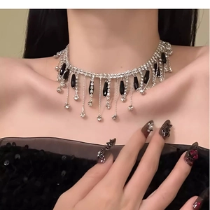 Elegant close-up of a sparkly rhinestone glass tassel choker necklace on a female model
