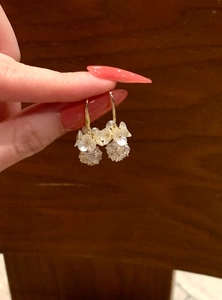 Detail showing elegant pearl flower earrings with faceted crystal ball pendants