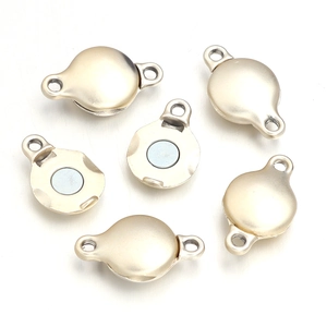 Macro shot of matte gold magnetic clasps for leather cord jewelry DIY projects