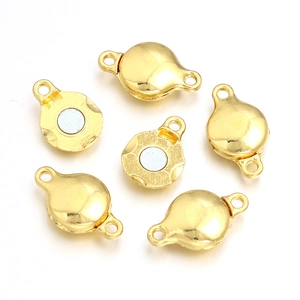 Close-up of 6 gold magnetic jewelry clasps for DIY bracelet and necklace connectors