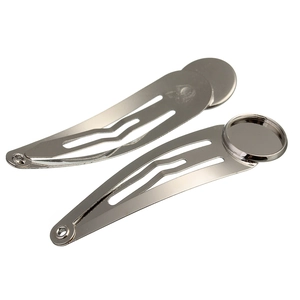 Macro detail of silver metal snap hair clips with round tray bases for DIY jewelry making