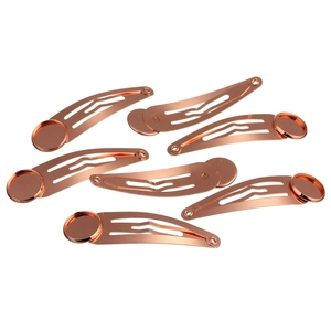 Close-up of rose gold DIY metal hair clip bases with round flat pads for crafting