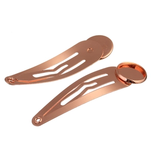 Close-up of rose gold metal BB hair clips with round flat base for DIY crafts