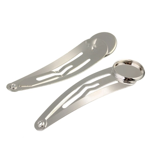 Detail of silver metal BB hair clips with round flat pad bases for DIY jewelry making