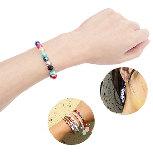 Colorful ABS pearl beaded bracelets and safety pin earrings set on hand with white background