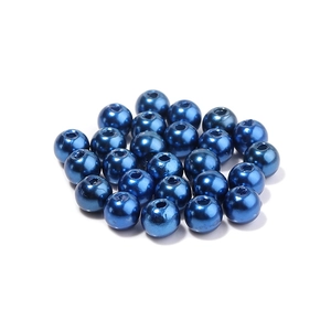 Macro detail of deep blue metallic ABS pearls with pre-drilled holes for DIY jewelry