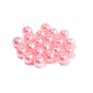 Macro shot of glossy pink pearl beads with holes for DIY jewelry making and crafts