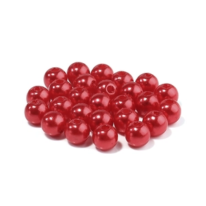 Close-up of vibrant red ABS imitation pearls with holes for DIY jewelry making
