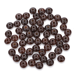 Detailed macro view of dark brown polished wooden loose beads for DIY jewelry making