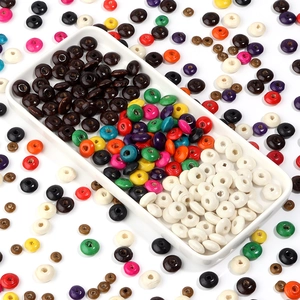Colorful flat round wooden abacus beads organized in a tray for DIY jewelry making