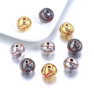 Macro view of gold silver and black basketball charms for DIY jewelry making