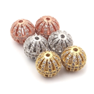 Macro detail of hollow copper beads with micro-pave cubic zirconia for DIY jewelry