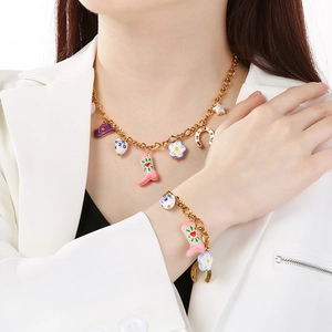 Detailed view of vintage Western cowboy jewelry set with colorful enamel charms on a model.
