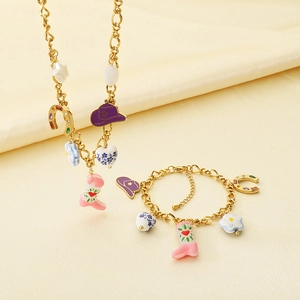 Close-up of vintage Western cowboy style jewelry set with pink boot and floral charms