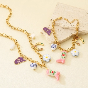 Close-up of Western style gold chain necklace and bracelet set with colorful charms