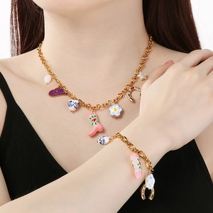 Detailed view of vintage cowboy necklace and bracelet set featuring colorful enamel charms