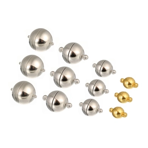 Macro shot of spherical magnetic jewelry clasps in gold and silver for DIY necklace making