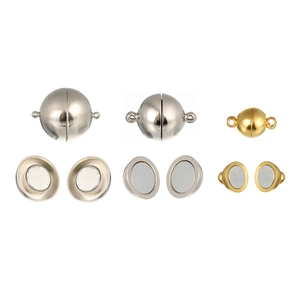 Close-up of spherical magnetic clasps for jewelry DIY in gold and silver finishes