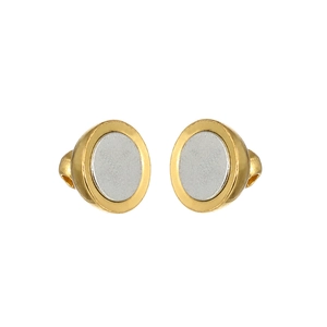 Detailed view of two-tone metal stud earrings with gold and silver matte textures