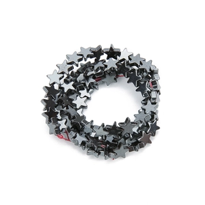 Macro shot of star-shaped hematite spacer beads with metallic grey finish for DIY jewelry