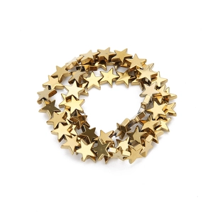 Close-up of vacuum-plated gold star-shaped beads for DIY jewelry making and necklaces