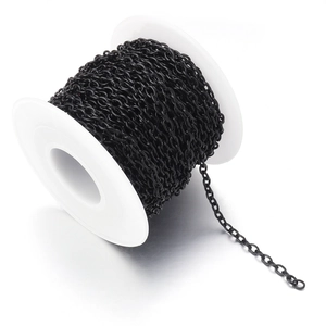 Macro view of 2mm black metal O-chain on white spool for DIY jewelry making and crafting