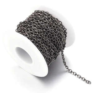 Detailed view of gunmetal 2mm flat oval link chain on a spool for DIY jewelry making