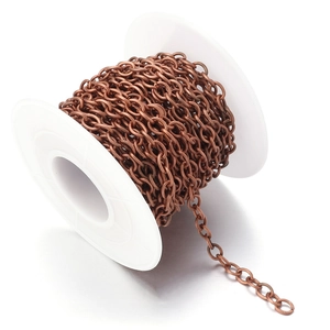 Detailed view of 2mm red antique bronze metal chain links on a white plastic spool