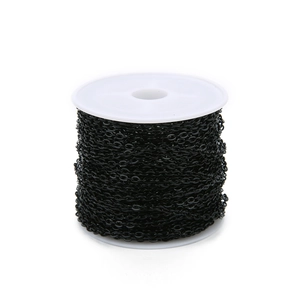 Detail showing high-gloss black plated flat cross chain on a white spool for DIY jewelry