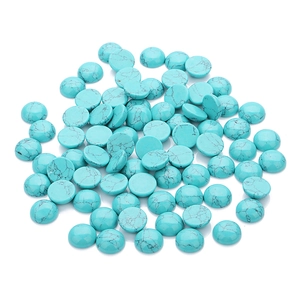 Macro view of round turquoise cabochon stones with black vein texture for DIY jewelry