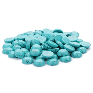 Detailed view of turquoise cabochon stones with natural black matrix veins on white background