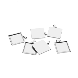 Macro detail of six square stainless steel pendant trays for DIY jewelry making