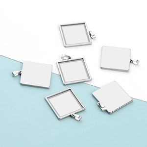 Detailed macro view of square stainless steel pendant tray bases for DIY jewelry making