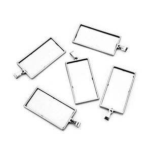 Macro shot of silver stainless steel square pendant trays for DIY jewelry making