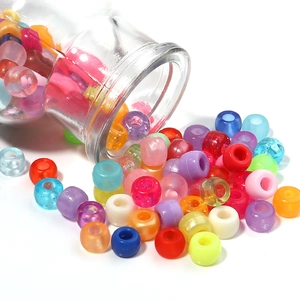 Macro di perle colorate in acrilico con foro grande che escono da un vaso per gioielli fai-da-te