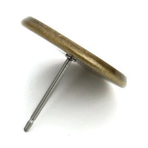 Macro view of vintage bronze stud earring base with silver pins for DIY jewelry making