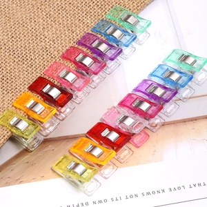 Colorful plastic sewing clips with scale markings for patchwork and fabric positioning