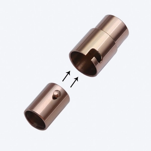 Macro detail of rose gold stainless steel magnetic clasps with assembly arrows