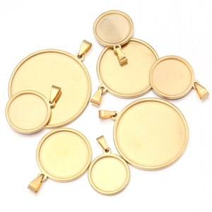 Flat lay of gold plated stainless steel round pendant trays for DIY jewelry making