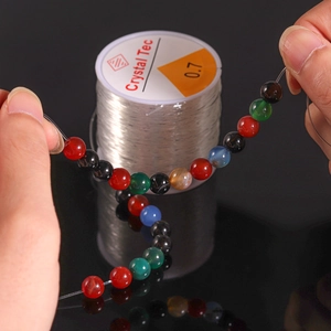 Close-up of 0.7mm elastic crystal thread used for stringing colorful gemstone beads