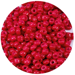 Macro shot of vibrant red glass seed beads with center holes for DIY jewelry making