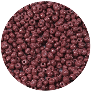 Macro detail of dark red 2.5-4mm glass seed beads with a polished smooth finish